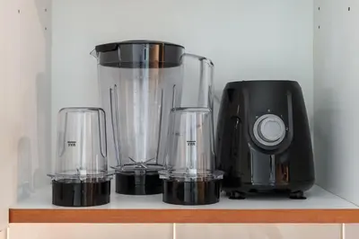 a blender and three glasses on a shelf at Luxury JLT Studio Lake View Metro 5minMarina in Dubai