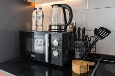 a black coffee maker on a counter in a kitchen at Luxury JLT Studio Lake View Metro 5minMarina in Dubai