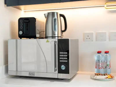 a coffee maker on top of a microwave at Huge Lux 1BHK in Prime Business Bay with Private Jacuzzi in Dubai