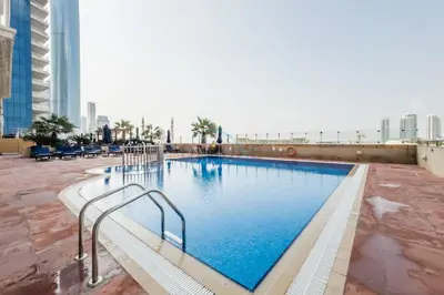 a large swimming pool on the roof of a building at Upgraded 2BR with Partial Sea View Near to Dubai Tram, Elite Residence, Dubai Marina by Deluxe Holiday Homes in Dubai