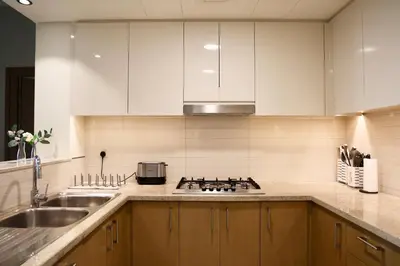 a kitchen with a sink and a stove top oven at Nivis find-Burj Vista-Direct access to Dubai mall in Dubai