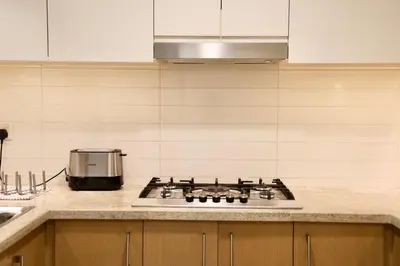 a kitchen with a stove top in a kitchen at Nivis find-Burj Vista-Direct access to Dubai mall in Dubai