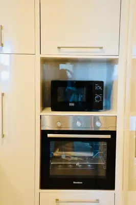 a microwave oven sitting inside of a kitchen at Nivis find-Burj Vista-Direct access to Dubai mall in Dubai