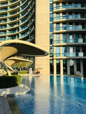 a swimming pool in front of a tall building at Nivis find-Burj Vista-Direct access to Dubai mall in Dubai