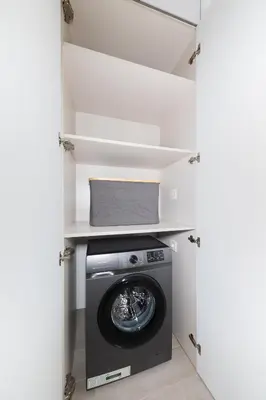 a washer and dryer in a laundry room at Luma Studio in Jumeirah Village Circle in Dubai