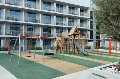 a playground in front of a building at Luma Studio in Jumeirah Village Circle in Dubai