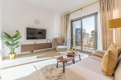a living room with a couch and a large window at Balcony Overlooking the Swimming Pool, Just Minutes from the Park, Town Square Safi 1A, Al Yelayiss 2 by Deluxe Holiday Homes in Dubai