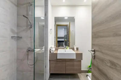 a bathroom with a sink and a shower at HAVN - New Studio Apartment in Bloom Towers, JVC in Dubai