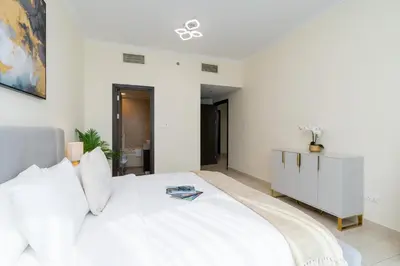 a white bedroom with a large white bed in it at Classy Upgraded High Floor Prime Location in Dubai