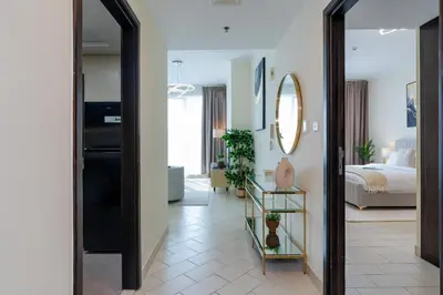 a hallway with a mirror and a bedroom at Classy Upgraded High Floor Prime Location in Dubai