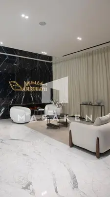 a living room with two white couches and a stage at Bright Studio Burj Khalifa & Canal Views Pool in Dubai