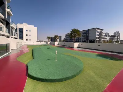 a golf course on the roof of a building at Frank Porter - Samana Golf Avenue in Dubai