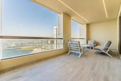 an office with a large window and a table and chairs at Sea and Palm Jumeirah Views Just Steps from the Beach 2BR, Sadaf 6 , JBR by Deluxe Holiday Homes in Dubai