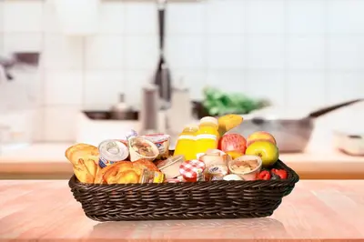 a basket filled with different types of food on a table at Serene Seaside Stay - 2BR in Bluewaters with Sea View in Dubai