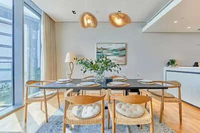 a dining room with a table and chairs at Serene Seaside Stay - 2BR in Bluewaters with Sea View in Dubai