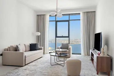 a living room with a couch and a tv at Silkhaus Waterfront 1BR in Marina Vista Tower in Dubai