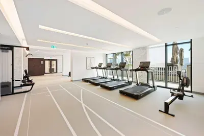 a gym with a row of treadmills and ellipticals at Silkhaus Waterfront 1BR in Marina Vista Tower in Dubai