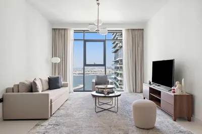 a living room with a couch and a tv at Silkhaus Waterfront 1BR in Marina Vista Tower in Dubai