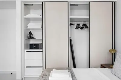 a bedroom with mirrored closets and a bed at Silkhaus Waterfront 1BR in Marina Vista Tower in Dubai