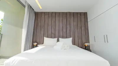 a bedroom with a white bed with two towels on it at Lavish Sidra 3 Villa, 4BR plus M,Private Pool BBQ in Dubai