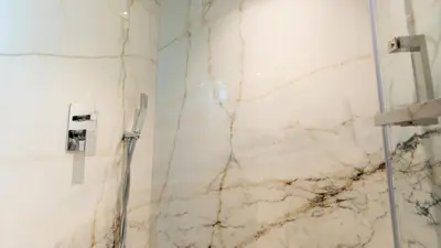 a bathroom with a marble wall and a shower at Lavish Sidra 3 Villa, 4BR plus M,Private Pool BBQ in Dubai