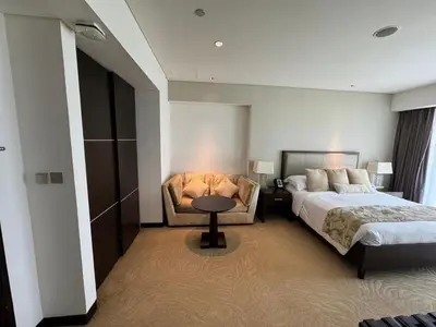 a bedroom with two beds and a table and a chair at Stylish studio Located in JW Mariott Hotel Dubai Marina in Dubai