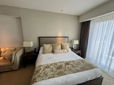 a hotel room with a large bed and a couch at Stylish studio Located in JW Mariott Hotel Dubai Marina in Dubai