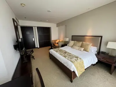 a bedroom with a large bed and a television at Stylish studio Located in JW Mariott Hotel Dubai Marina in Dubai