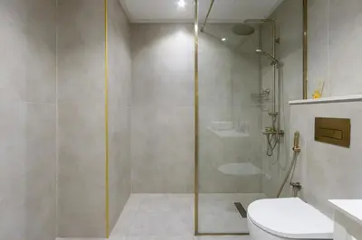 a bathroom with a shower and a toilet at Livbnb-Stylish 1B with Spacious Balcony in JVC in Dubai