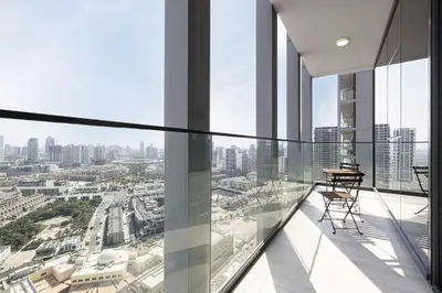 a balcony in a building with a view of a city at Stylish 1-Bedroom Apartment with Premium Amenities in Dubai