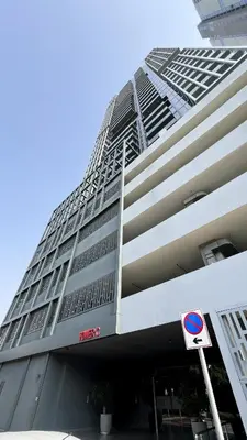 a tall building with a sign in front of it at Stylish 1-Bedroom Apartment with Premium Amenities in Dubai