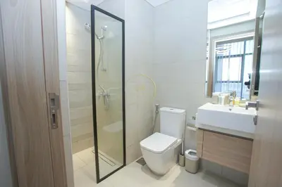 a bathroom with a toilet and a sink and a shower at Standard 2BHK located in Azizi riviera 46 in Dubai