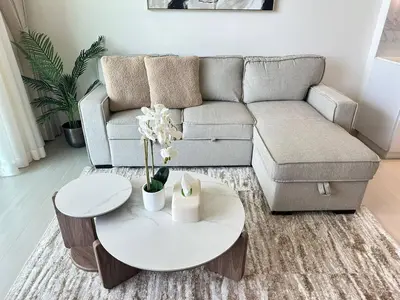 a living room with a couch and a table at Comfortable 1br Jvc Balcony Parking in Dubai