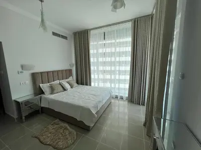 a bedroom with a bed and a large window at Opal Tower, Marina in Dubai