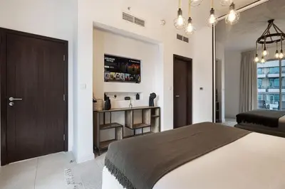 a bedroom with a bed and a sink in it at Breathtaking Views & Contemporary Comfort in the Heart of Downtown in Dubai
