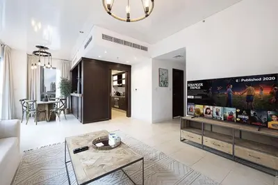 a living room with a couch and a table at Breathtaking Views & Contemporary Comfort in the Heart of Downtown in Dubai