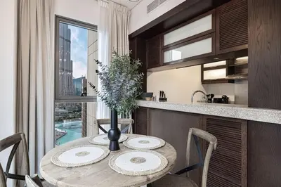 a kitchen with a table with a vase on it at Breathtaking Views & Contemporary Comfort in the Heart of Downtown in Dubai