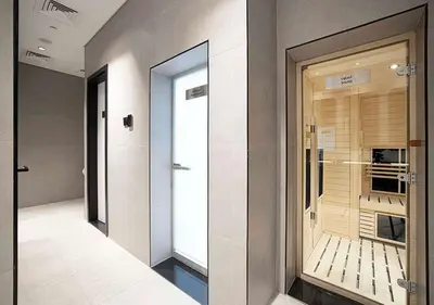 a hallway with a glass door in a building at Chic Studio with Top Amenities in Dubai