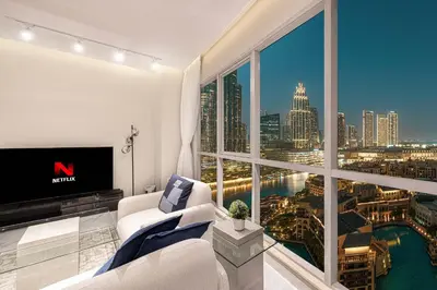 a living room with a view of a city at Downtown Sanctuary Iconic Burj Views & Luxury Living in Dubai