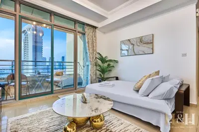a living room with a bed and a table at Dubai Marina Sea View Sunset View Dubai Eye View in Dubai