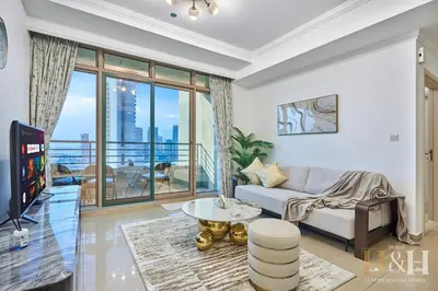a living room with a couch and a table at Dubai Marina Sea View Sunset View Dubai Eye View in Dubai