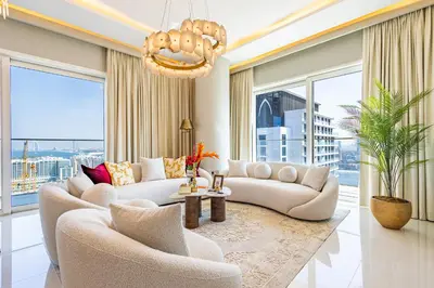a living room with two couches and a chandelier at Lux Designer 2BR - Grand Bleu - Waterfront Living in Dubai