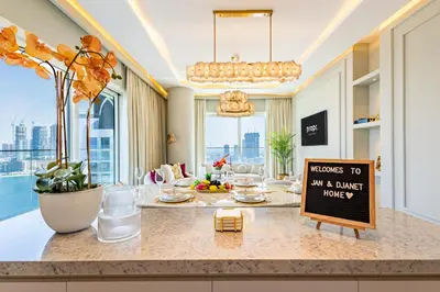 a kitchen with a counter with a sign on it at Lux Designer 2BR - Grand Bleu - Waterfront Living in Dubai