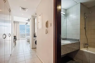 a bathroom with a tub and a sink and a shower at 021 - Discovery Gardens (Building 18) in Dubai