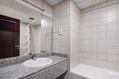 a bathroom with a sink and a mirror at 021 - Discovery Gardens (Building 18) in Dubai