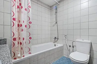 a bathroom with a tub and a toilet and a shower curtain at 021 - Discovery Gardens (Building 18) in Dubai
