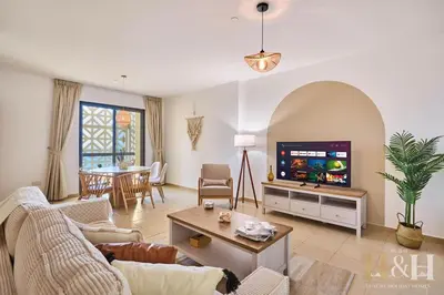 a living room with a couch and a tv at Stunning views of Dubai Sea, Dubai Eye & JBRWalk in Dubai