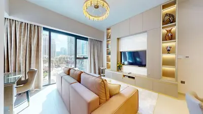 a living room with a couch and a television at Act One Act Two - Exquisite One Bed in Downtown in Dubai