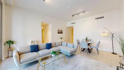 a living room with a couch and a table at Forte Tower - Aesthetic Three Bedroom in Downtown in Dubai
