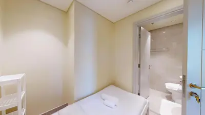 a small bathroom with a toilet and a shower at Forte Tower - Aesthetic Three Bedroom in Downtown in Dubai